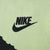 Close-up of black Nike logo and Swoosh printed on neon yellow fabric
