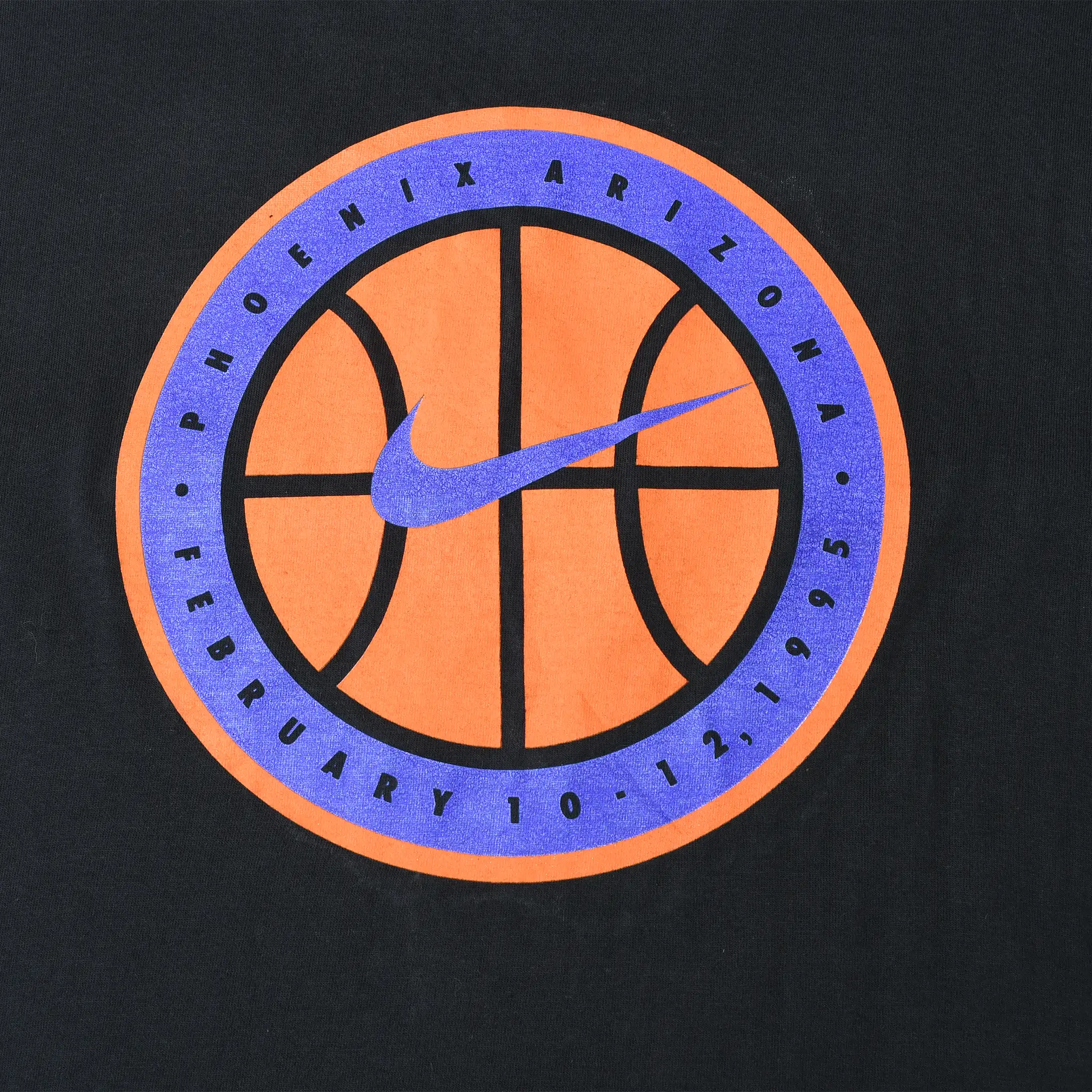 Close-up of orange and purple basketball back graphic reading Phoenix Arizona, February 10, 1995