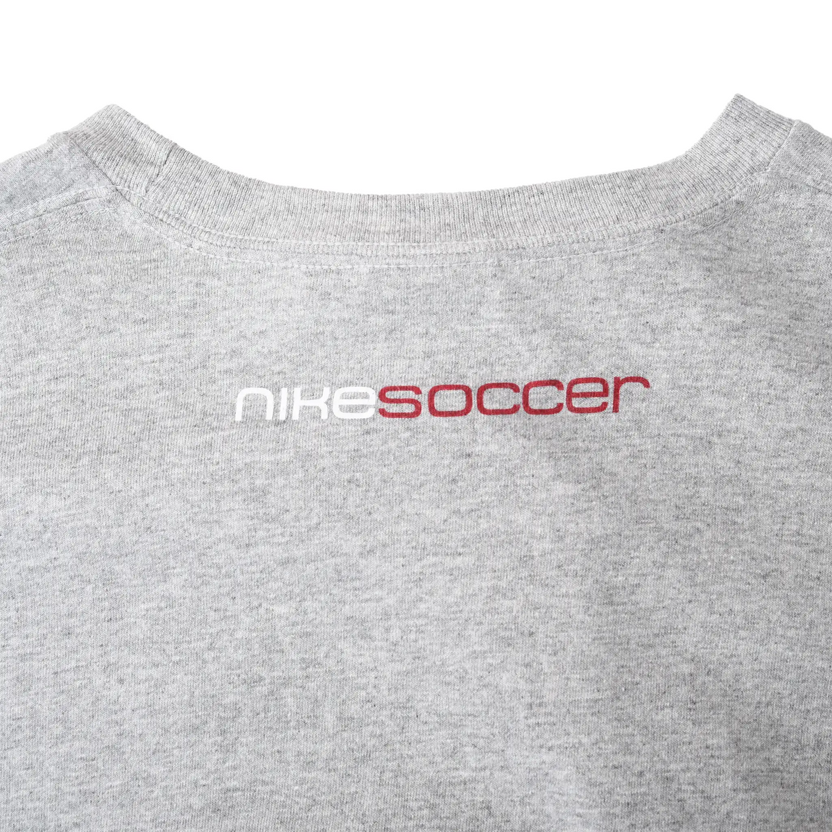 Close-up of white and red Nike Soccer print below the back collar
