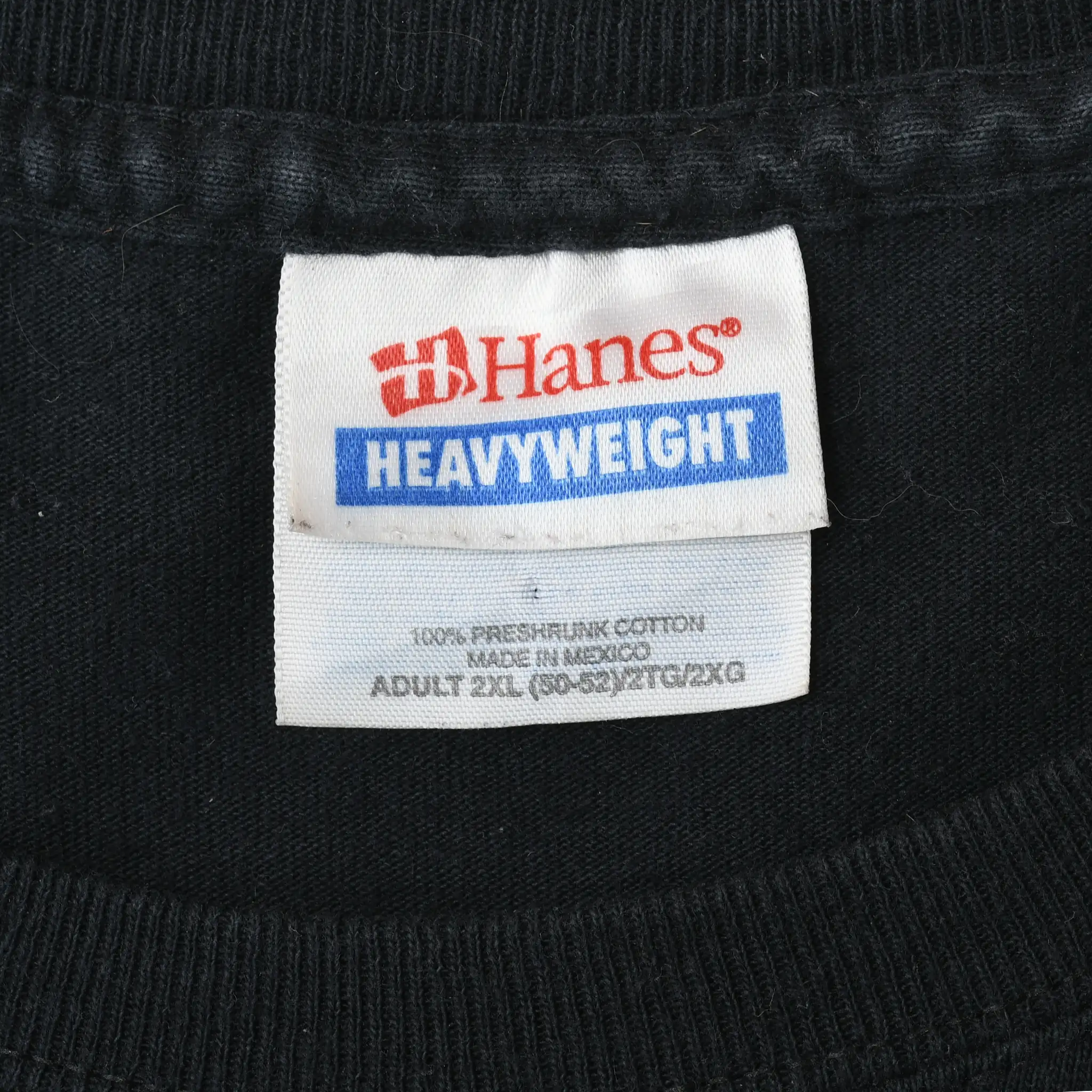 Close-up of Hanes Heavyweight neck label inside black T-shirt