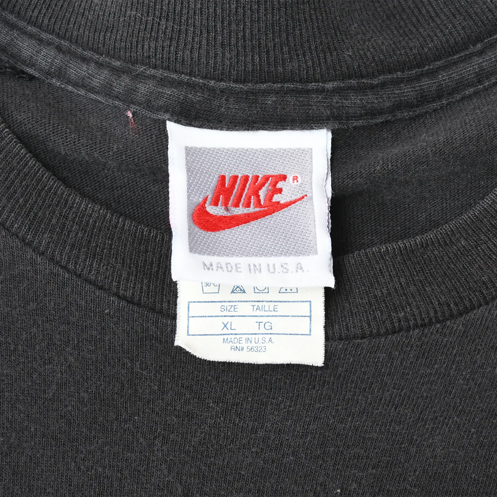 Close-up of Nike neck labels showing Made in USA and size XL