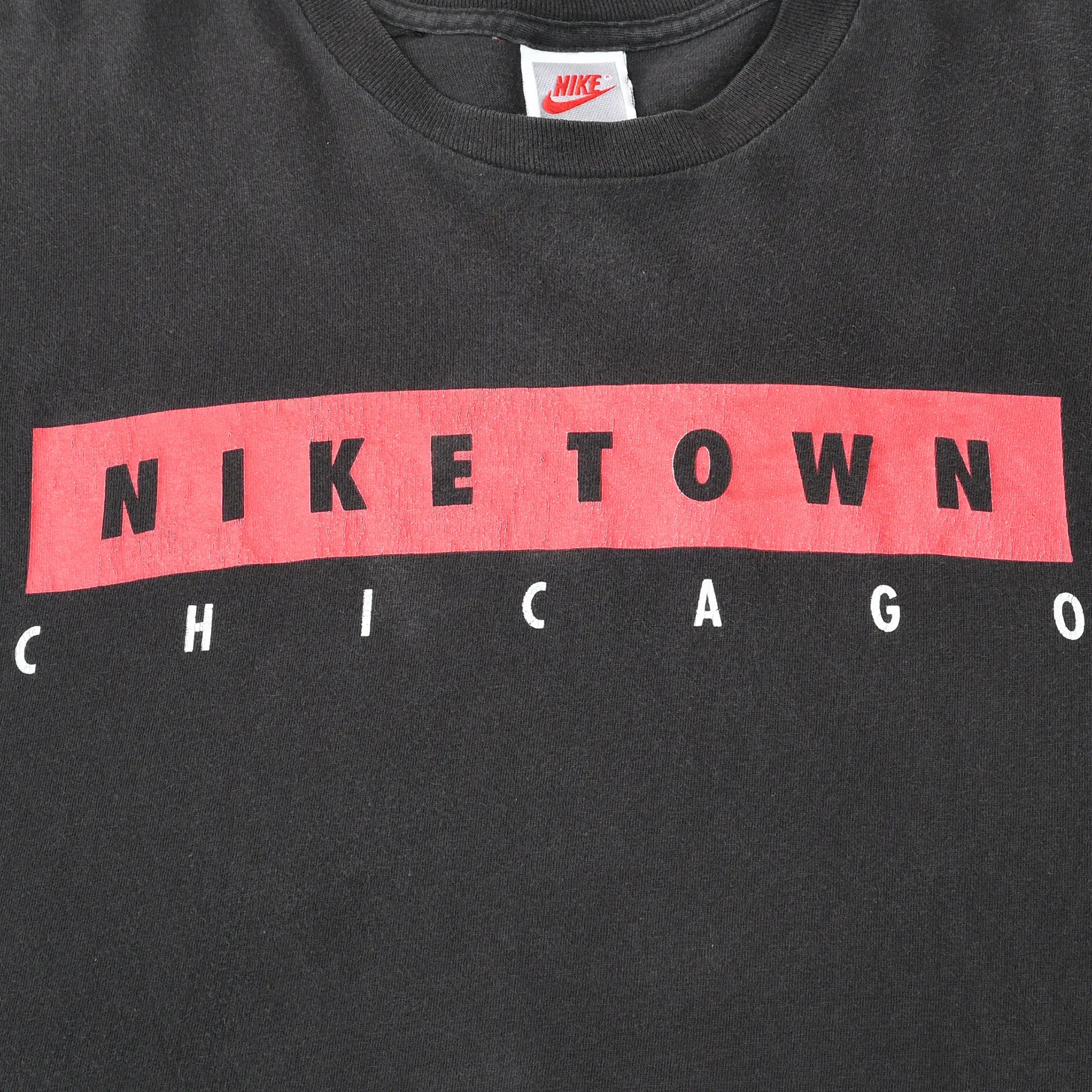 Close-up of red, black, and white Nike Town Chicago chest print