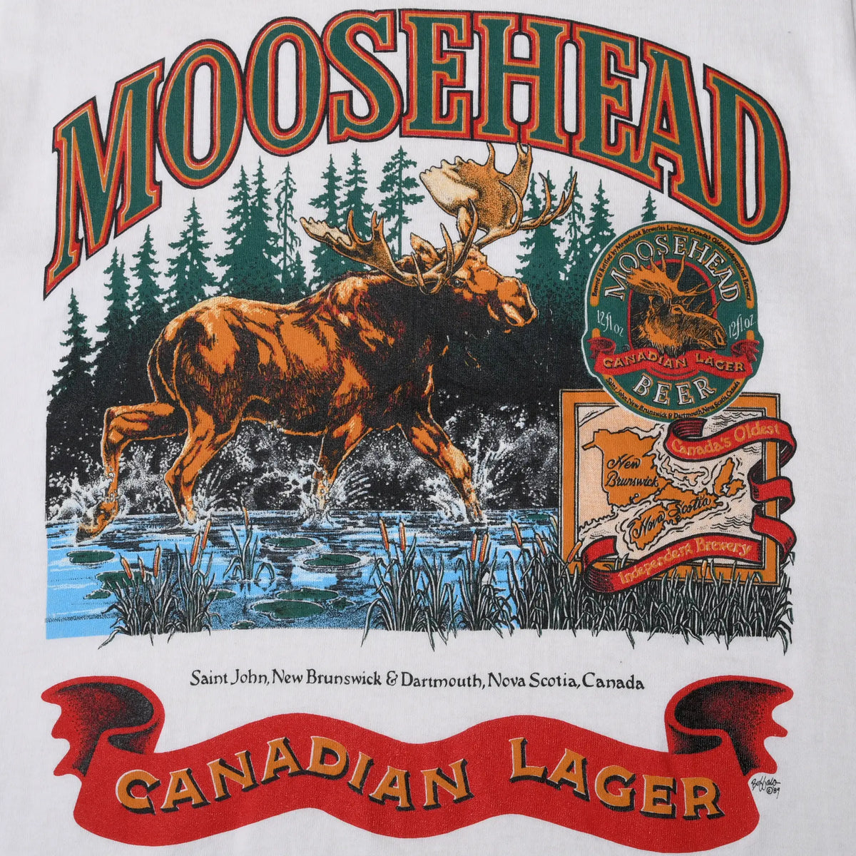 Close-up of Moosehead Canadian Lager print with moose, forest, label, and red banner