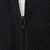 Close-up of black front zipper and surrounding fabric on Nike windbreaker