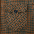 Close-up of button-flap chest pocket and brown and green plaid wool fabric