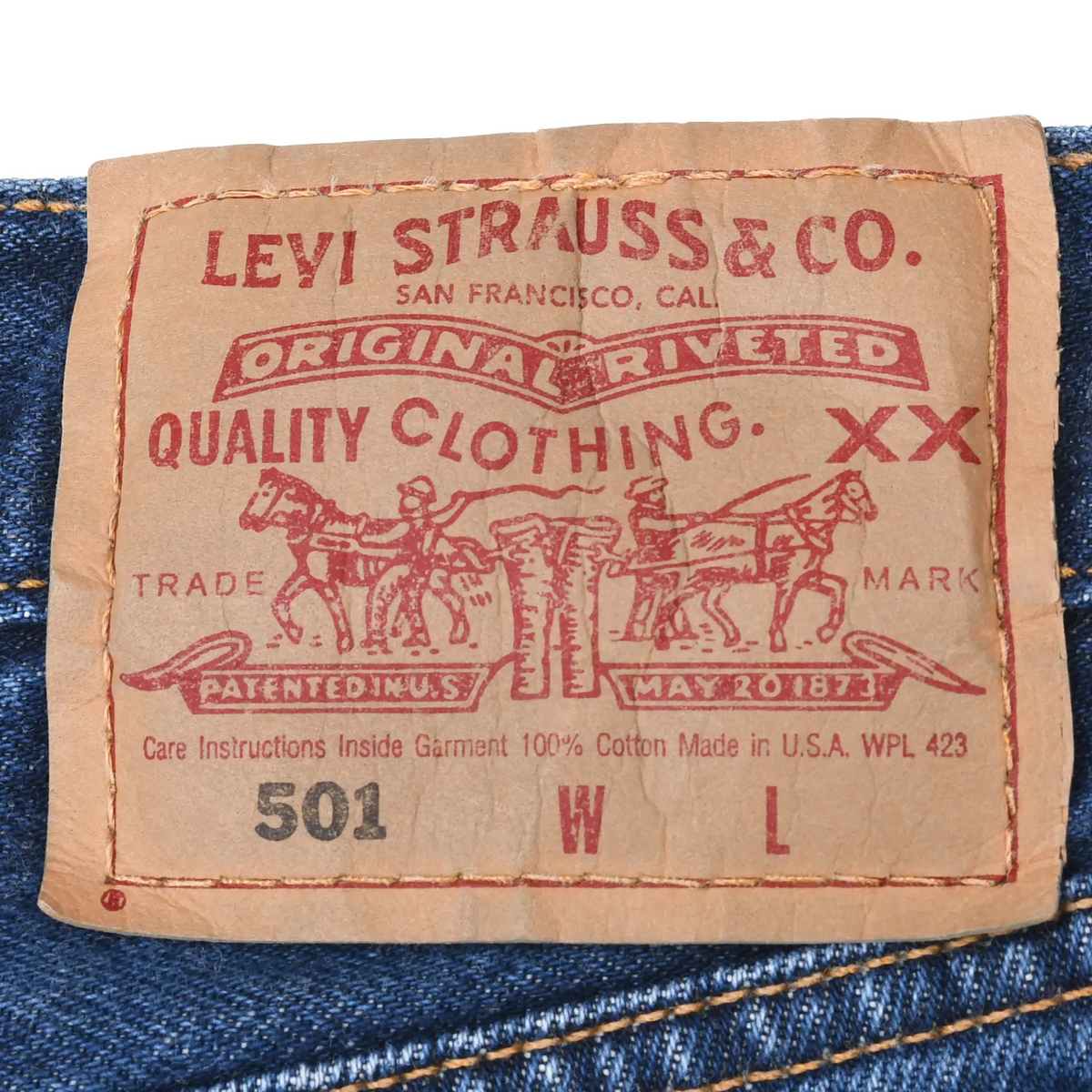 Close-up of Levi Strauss & Co. 501 waistband patch on blue denim