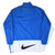 Back of blue Nike windbreaker with white lower panel and large black Swoosh print