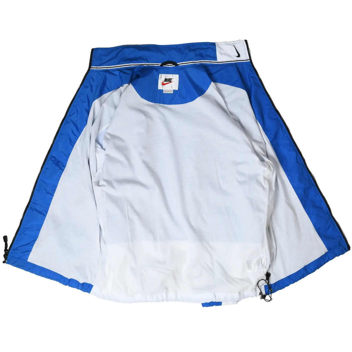 Open Nike windbreaker showing white interior lining, neck label, and drawcord hem