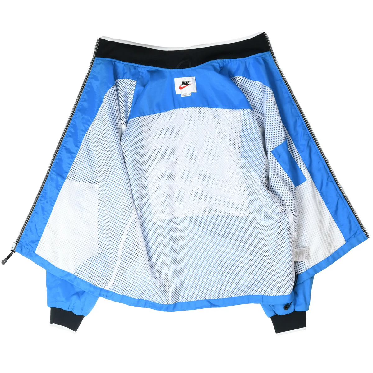 Open blue Nike windbreaker showing white mesh lining, interior label, and black collar