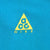 Close-up of yellow Nike ACG triangle logo embroidered on teal blue fabric