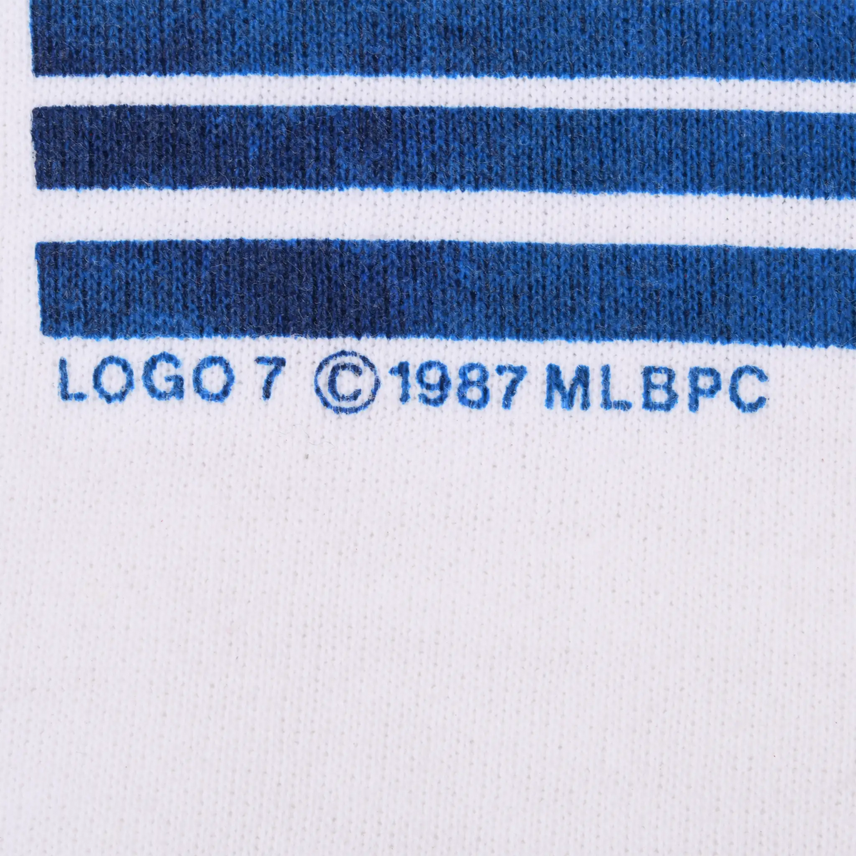 Close-up of blue stripes and Logo 7 copyright 1987 MLBPC text on the front graphic