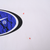 Close-up of faint spots on white fabric beside the oval Nike chest graphic, marked by red arrows