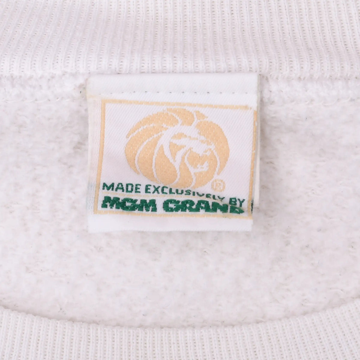 Close-up of MGM Grand lion neck label reading Made Exclusively by MGM Grand