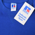 Close-up of Russell Athletic neck label and Authentic American Sport hangtag on blue sweatshirt