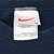 Nike neck label with red Swoosh, medium size, and Made in U.S.A. text
