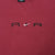 Close-up of black Air lettering and white Nike Swoosh embroidery on burgundy chest