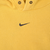 Close-up of small black Nike Swoosh embroidery centered below the hood opening