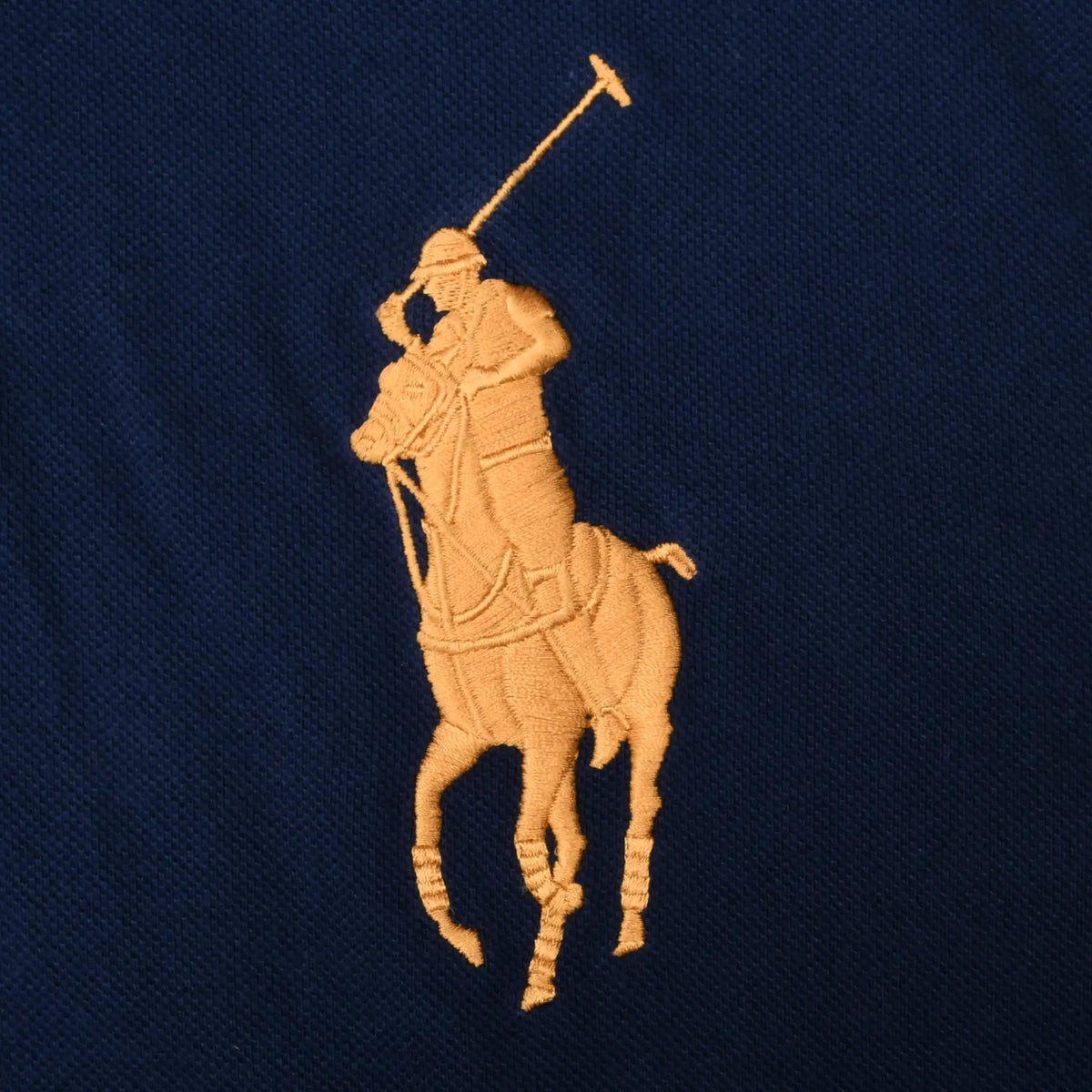 Close-up of gold Polo Ralph Lauren Big Pony embroidery on navy fabric