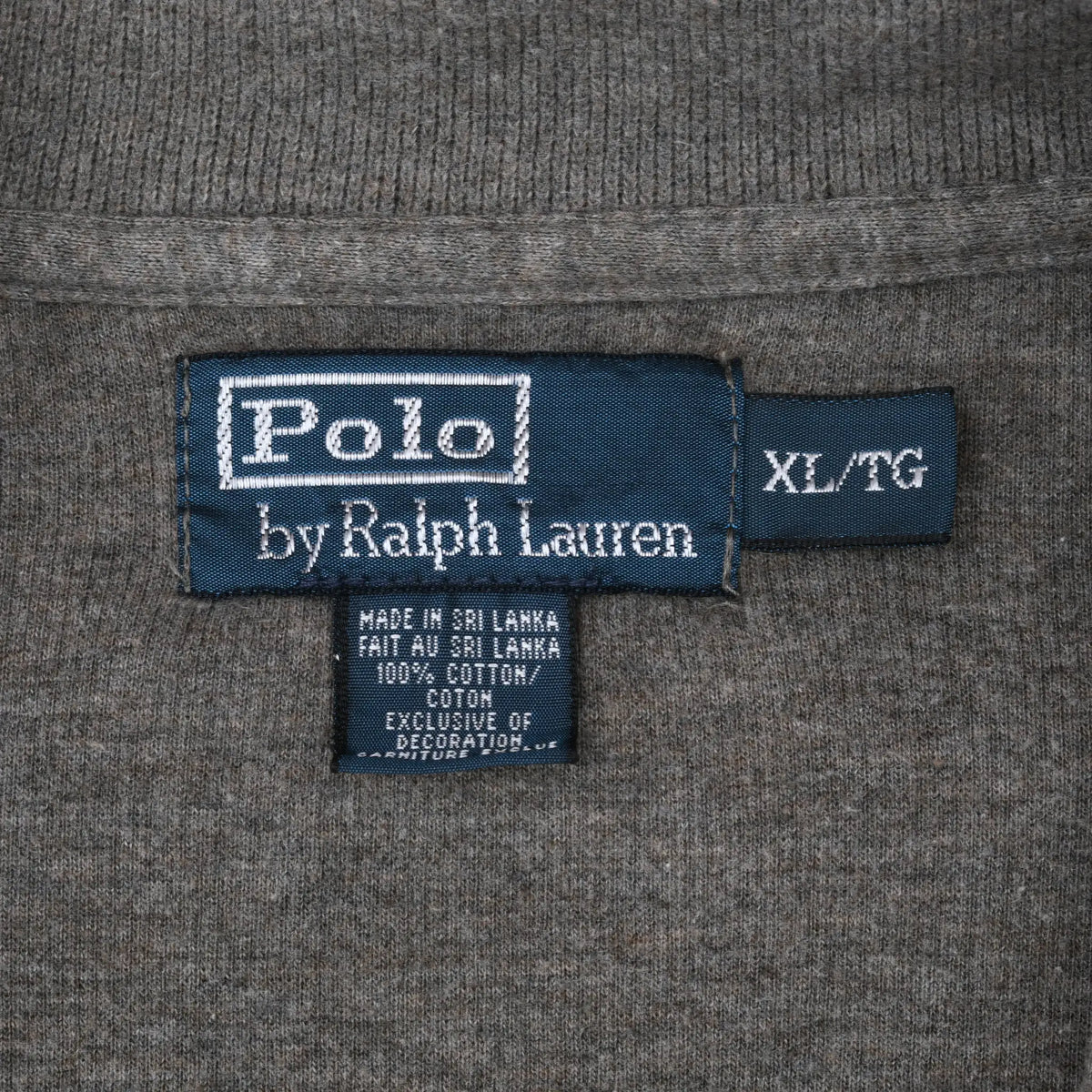 Close-up of Polo by Ralph Lauren neck label and XL/TG size tag on grey sweater