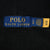 Close-up of blue Polo Ralph Lauren neck label and attached care tag inside black hoodie