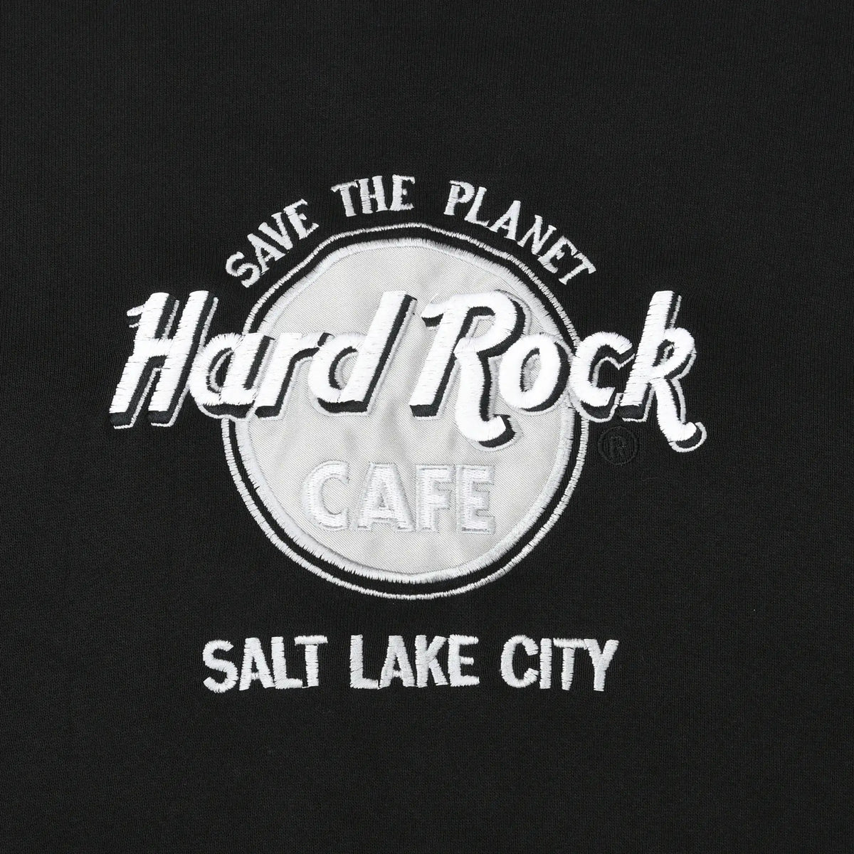 Close-up of white Save the Planet Hard Rock Cafe Salt Lake City embroidery