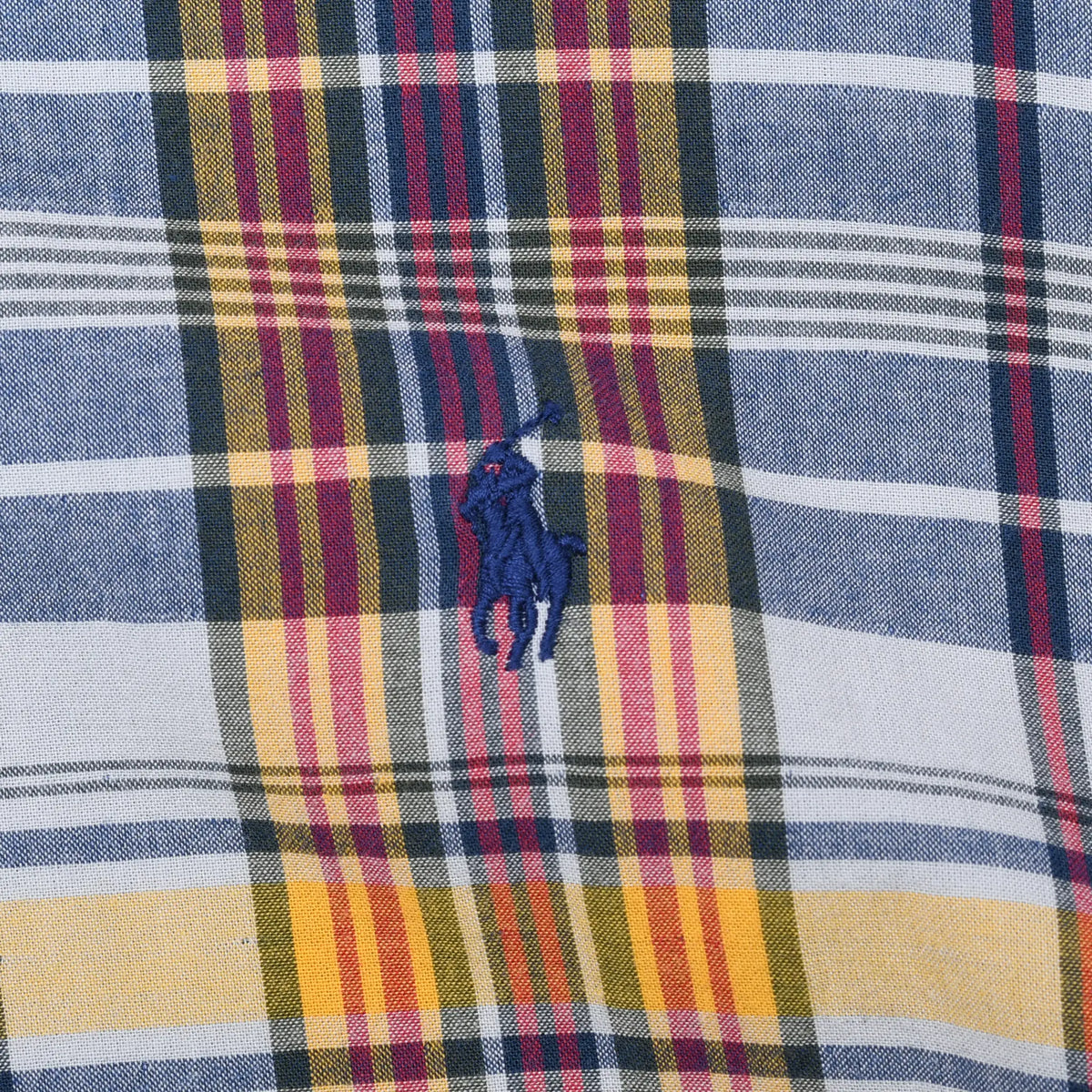Close-up of navy and red Ralph Lauren pony embroidery on multicolor plaid fabric