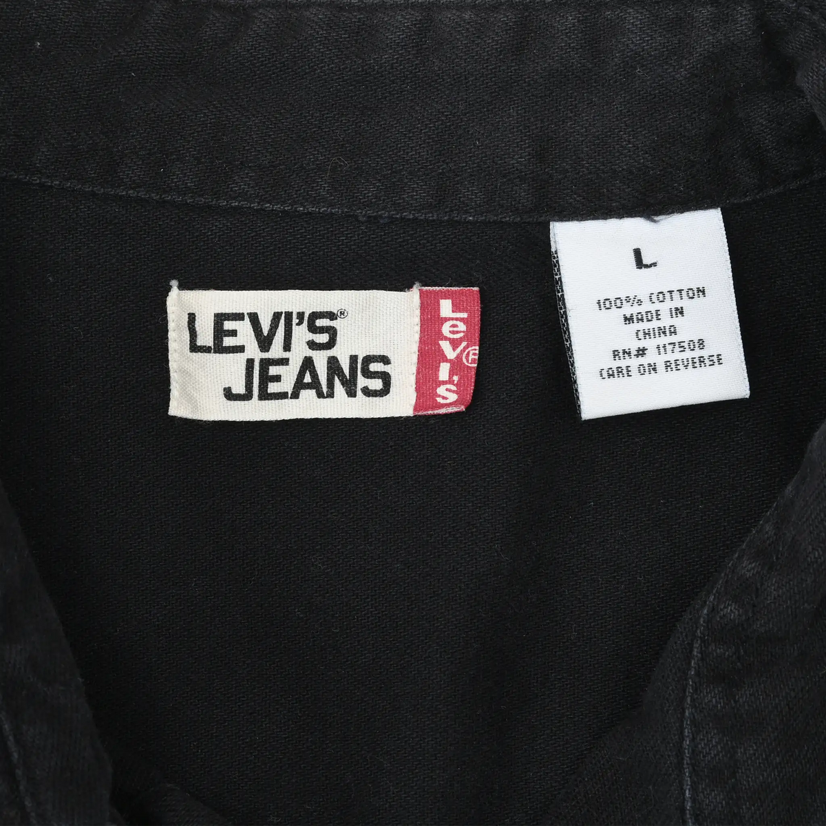 Close-up of Levi's Jeans neck label and large size tag inside black denim shirt