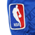 Close-up of embroidered NBA logo patch on blue jacket sleeve