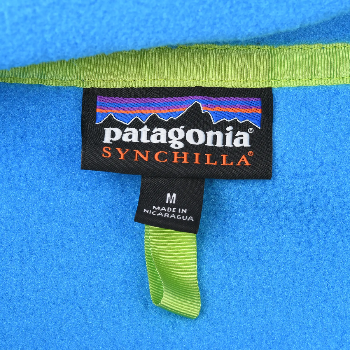Patagonia Synchilla neck label and medium size tag inside blue fleece pullover
