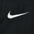 Close-up of white embroidered Nike Swoosh on black windbreaker fabric