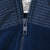 Close-up of quarter zipper and striped fabric on navy St. Louis Blues fleece jacket