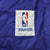 Close-up of NBA by Starter label stitched inside the purple jacket lining