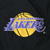 Close-up of purple and gold Los Angeles Lakers logo embroidery on black jacket chest