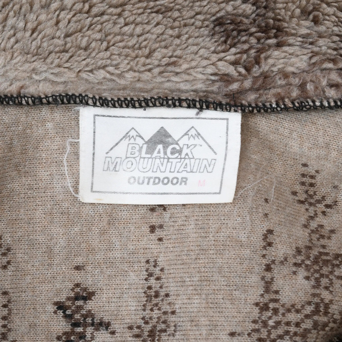 Black Mountain Outdoor neck label inside brown printed fleece jacket