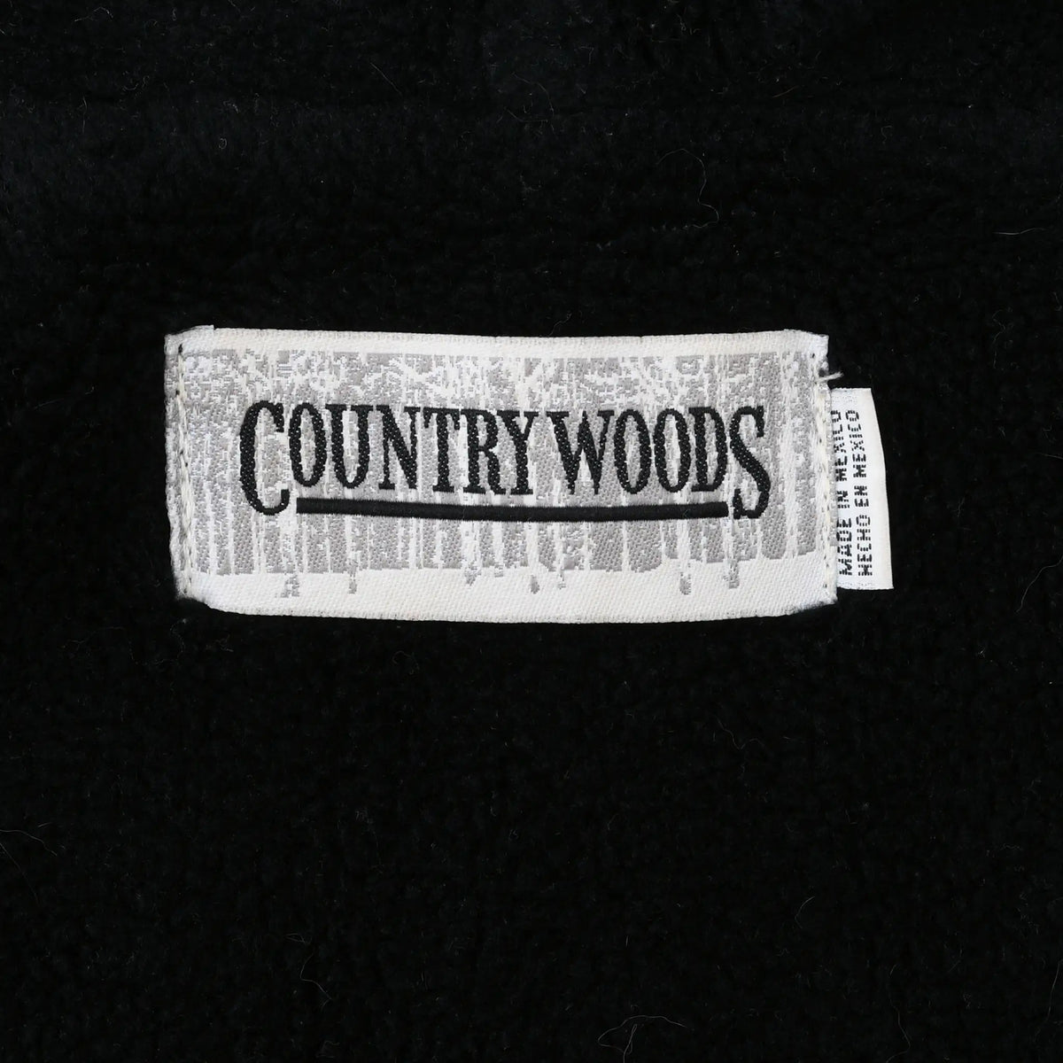 Country Woods brand label inside black fleece jacket lining
