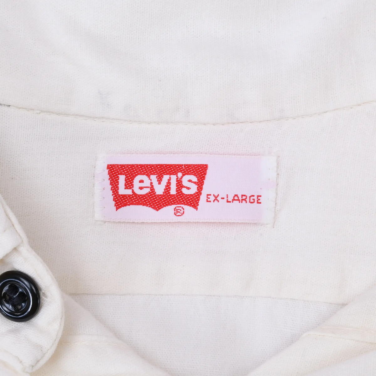 Close-up of red Levi's Extra-Large neck label inside the white shirt collar