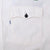 Close-up of white chest pocket with black button and small Levi's side tab