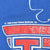 Close-up of distressed red print and United Feature Syndicate copyright text