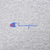 Close-up of the small blue and red Champion chest logo on heather gray fabric
