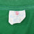 Close-up of Springfoot neck label inside green Peanuts T-shirt