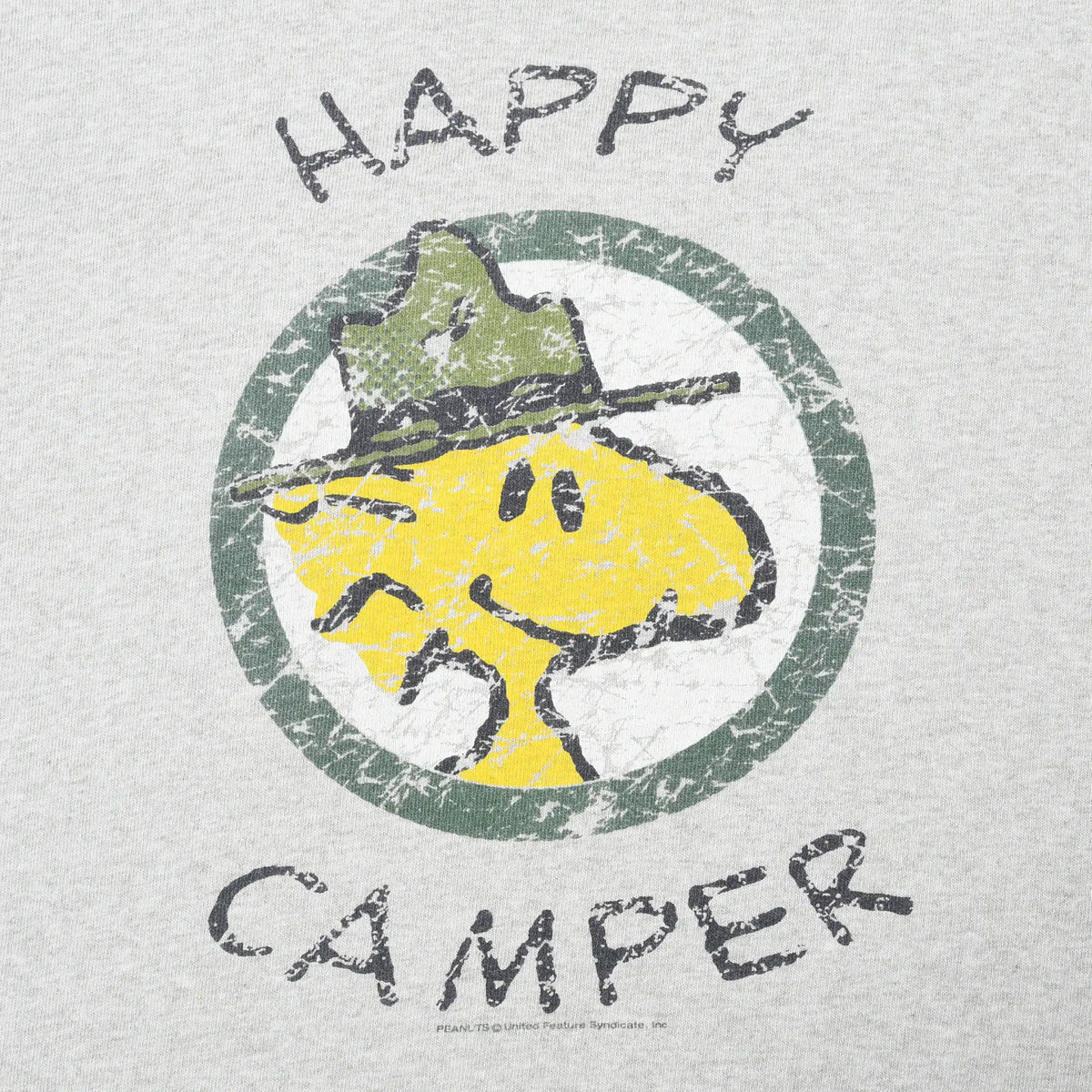 Close-up of distressed Woodstock Happy Camper graphic on gray T-shirt