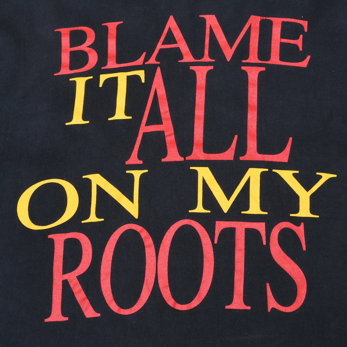 Close-up of red and yellow Blame It All on My Roots back print