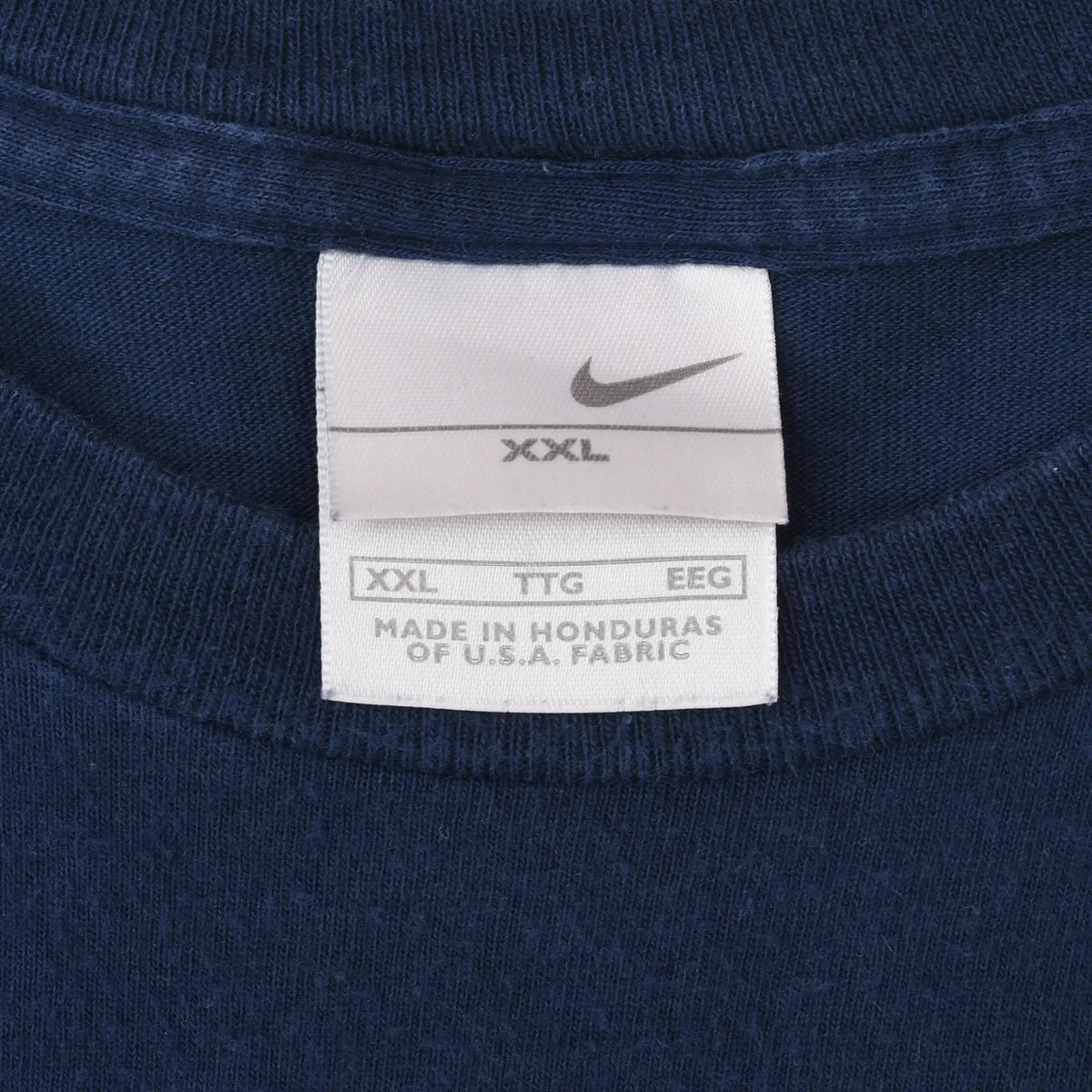 Close-up of Nike XXL neck label inside navy blue T-shirt