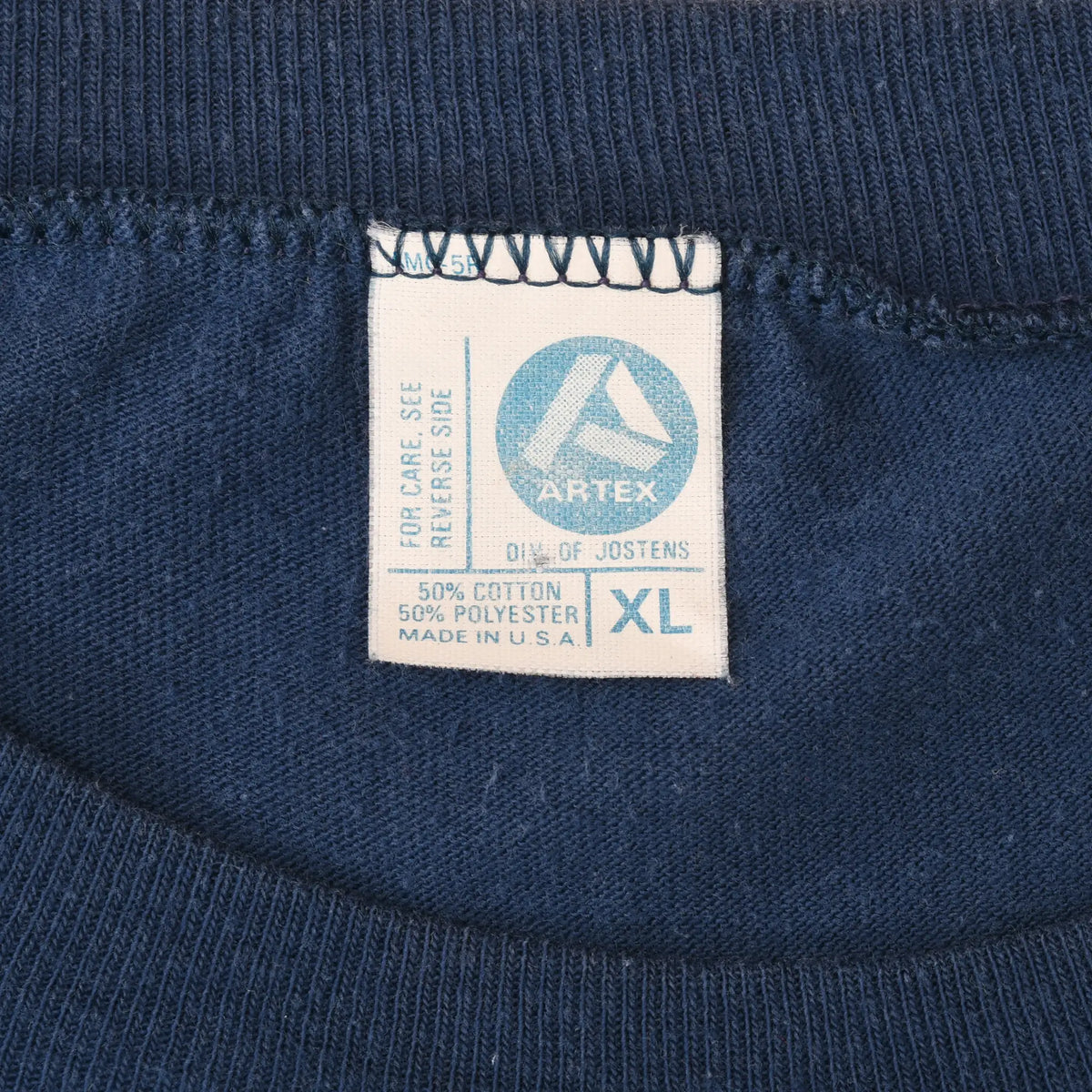 Close-up of Artex neck tag marked XL inside navy Chicago Bears T-shirt