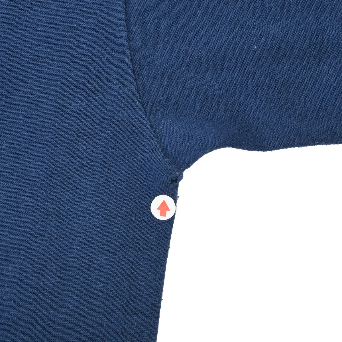 Close-up of small frayed area at the underarm seam of navy Chicago Bears T-shirt