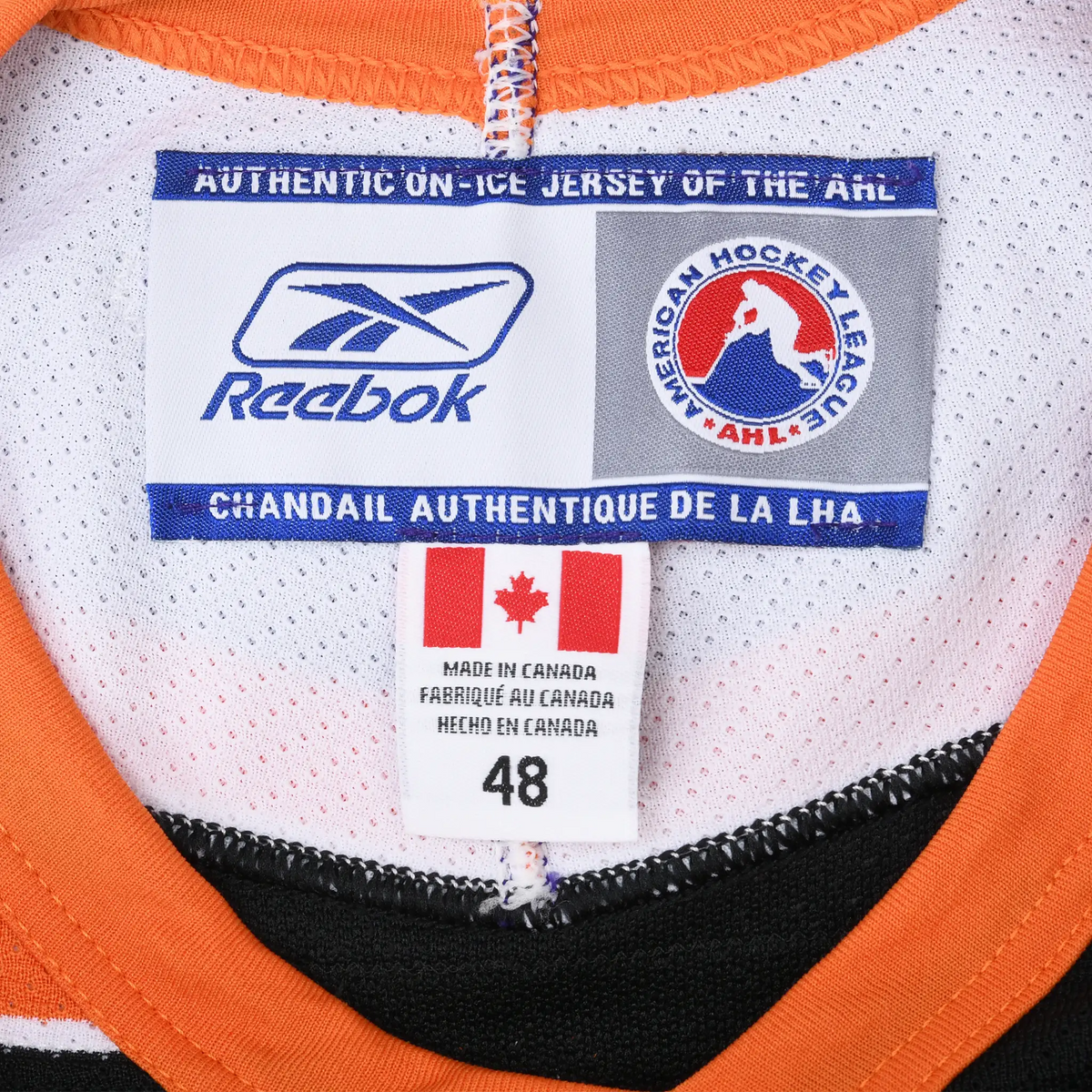 Reebok AHL neck label and size 48 tag inside Philadelphia Phantoms jersey