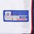 Close-up of Reebok NFL size 48 jock tag stitched to white mesh jersey fabric