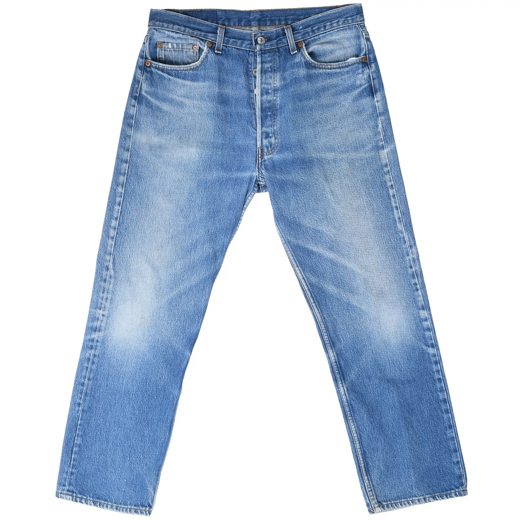 Front view of Levi's 501 blue jeans with button fly, five-pocket styling, and faded thighs