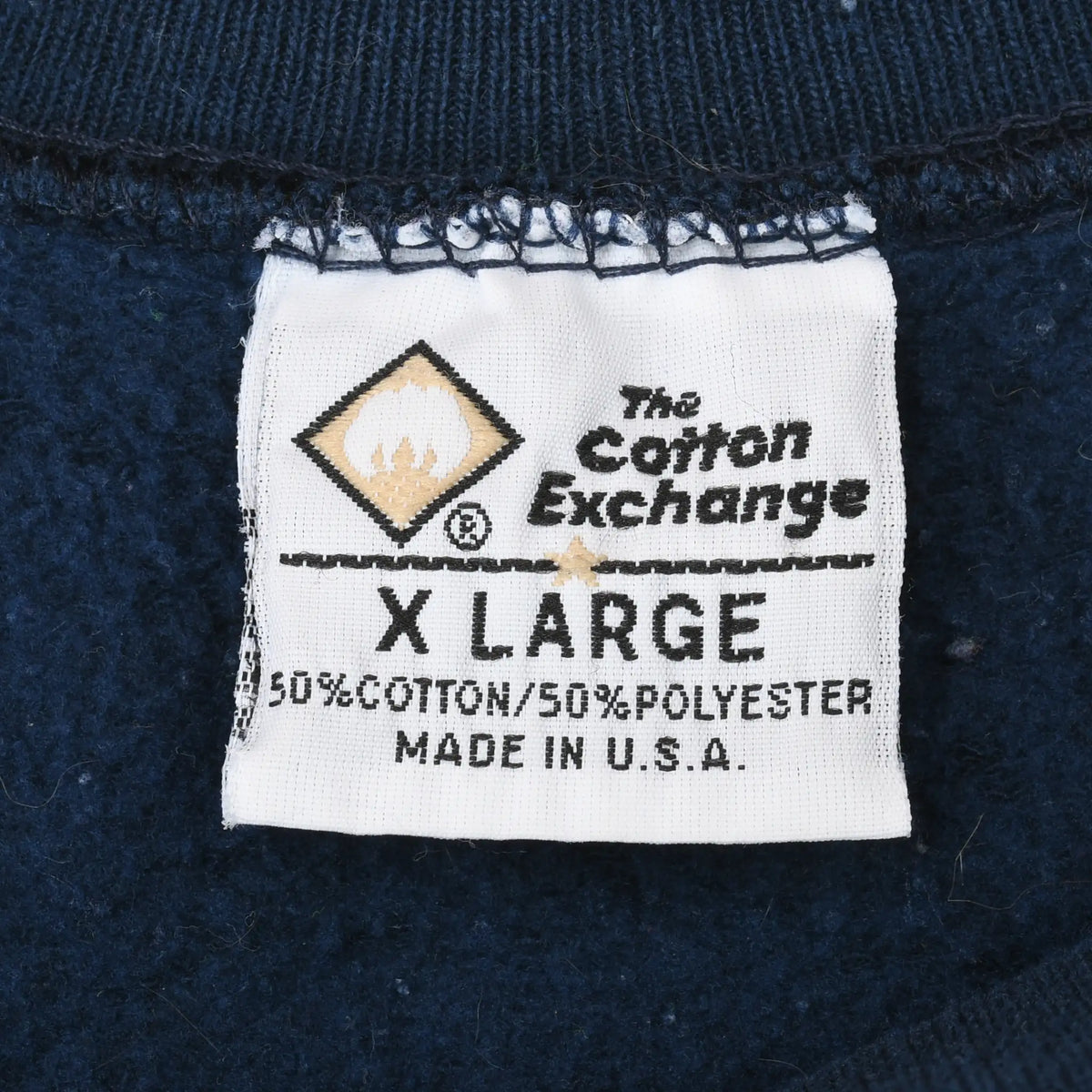 The Cotton Exchange neck label marked X Large, 50% cotton and 50% polyester, made in USA