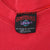 Close-up of Garment Graphics Active Wear neck label inside red sweatshirt